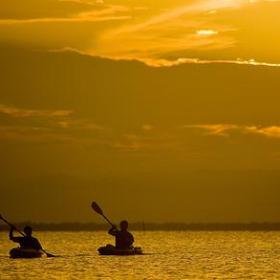 two kayakers at sunset