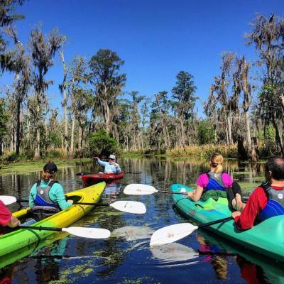 a tour guide talking to a group of kayakers