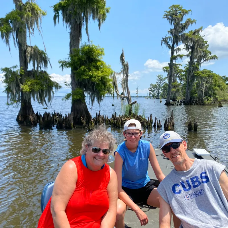 a group of people standing next to a body of water