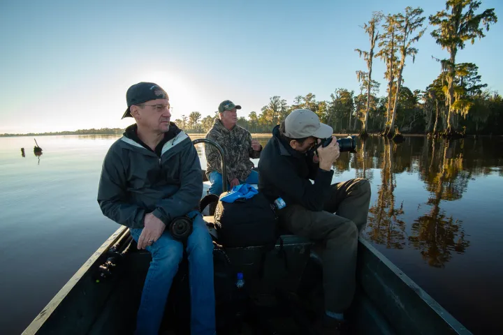 a man and woman sitting next to a body of water