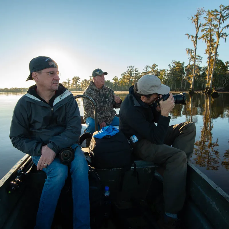 a man and woman sitting next to a body of water